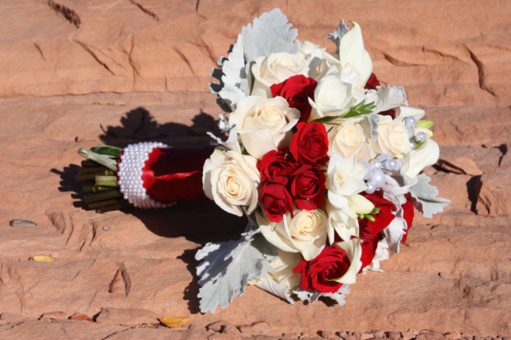 Wedding bouquet with cream roses,red spray roses,white calla lilies,dusty miller,pearls